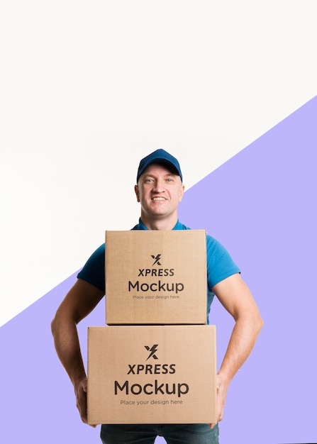 Download Free PSD | Front view delivery man holding some boxes mock-up