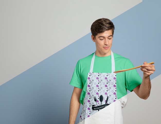 Download Free Psd Front View Of Man In Apron Holding Wooden Spoon