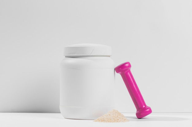 Front view white plastic bottle of protein and pink weight Free Psd