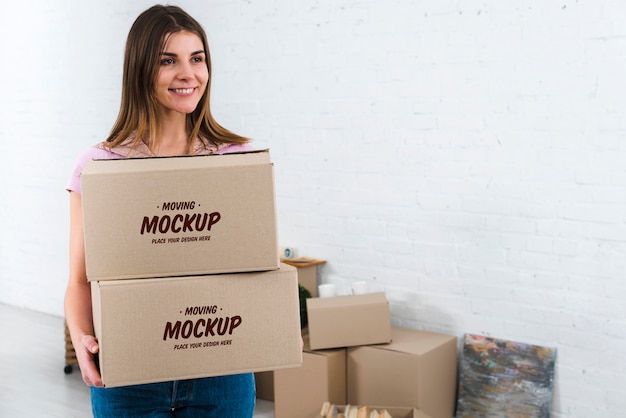 Download Free Psd Front View Of Woman Holding Moving Boxes Mock Up