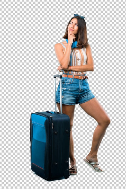 Girl traveling with her suitcase standing and thinking an idea while looking up Premium Psd