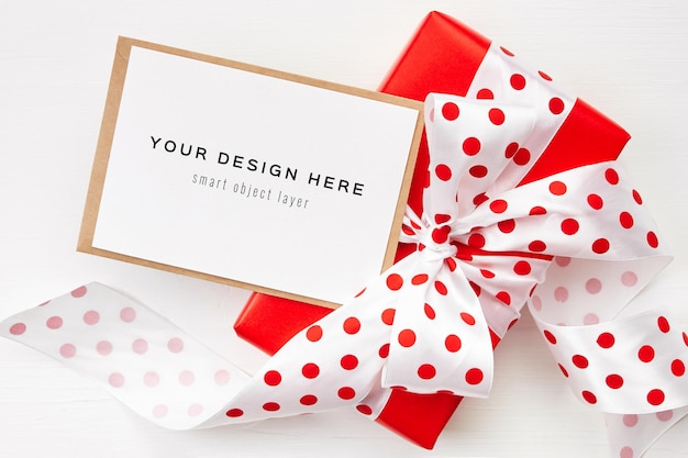 Download Premium PSD | Greeting card mockup with red gift box with bow