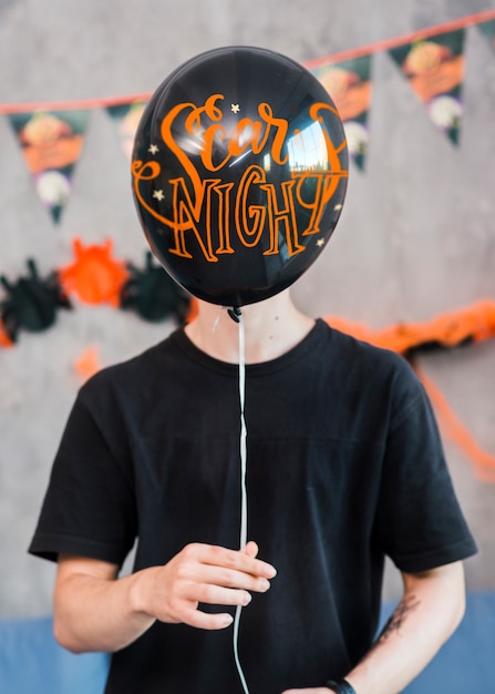 Download Free Psd Halloween Mockup With Man Holding Balloon