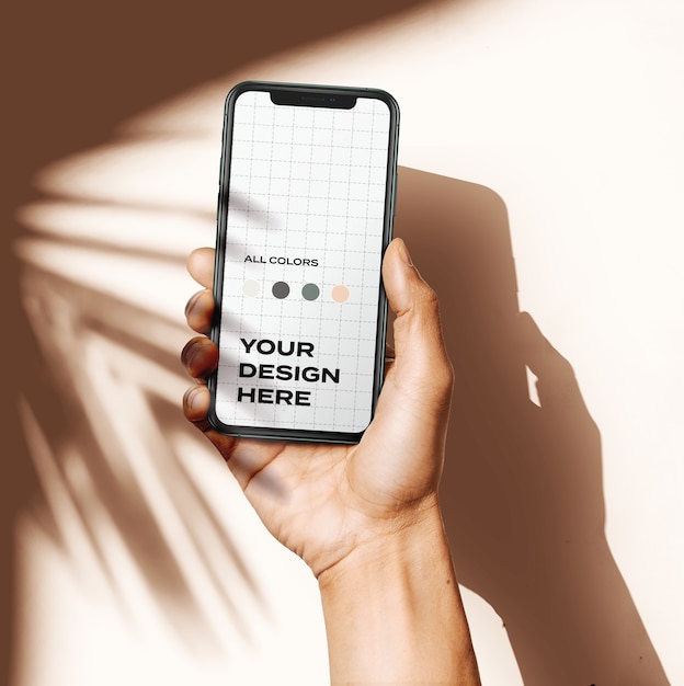 Premium PSD | Hand holding new smartphone mockup