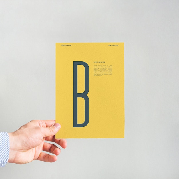 Download Hand holding yellow paper mockup PSD file | Free Download