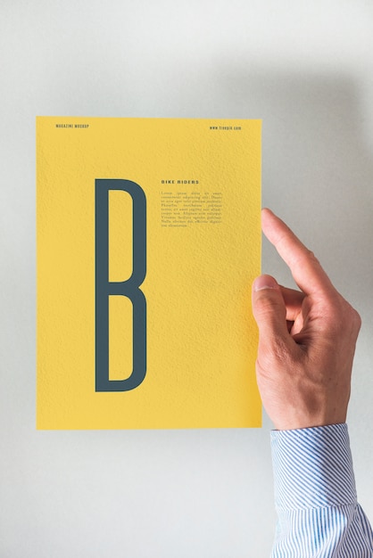 Free Psd Hand Holding Yellow Paper Mockup