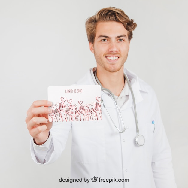 Download Free PSD | Happy doctor holding mock up