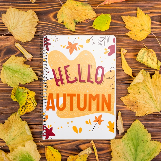 Hello autumn message on notebook with mock-up Free Psd