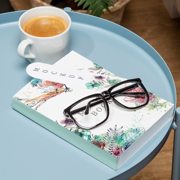 Download High angle book mock-up on coffee table with glasses and ...