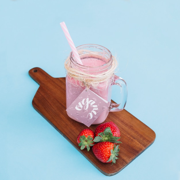 Download Jar mockup with pink yogurt and strawberries | Free PSD File