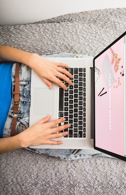 Download Laptop mockup on bed with hands | Free PSD File