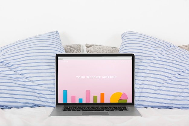 Download Laptop mockup on bed | Free PSD File