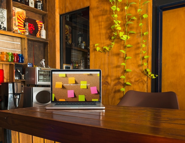 Download Laptop mockup on wooden table | Free PSD File