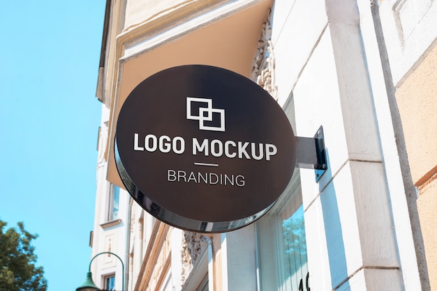 Download Free Logo Mockup On Round Street Sign Above The Store Modern Black Use our free logo maker to create a logo and build your brand. Put your logo on business cards, promotional products, or your website for brand visibility.