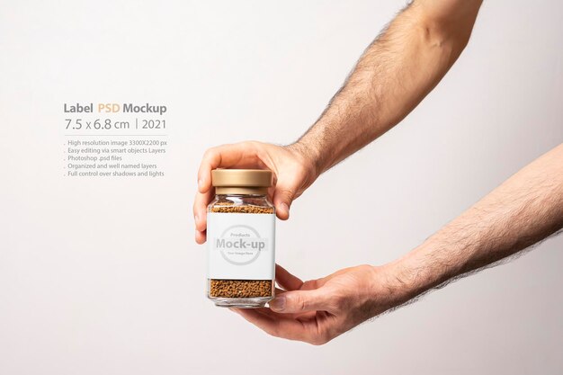 Download Premium Psd Male Hand Holding An Instant Coffee Glass Jar Mockup