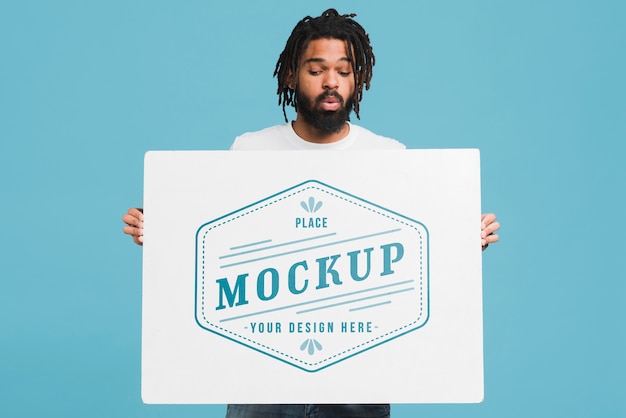 Download Man holding poster mockup | Free PSD File