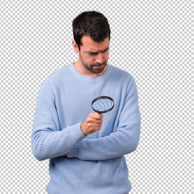 Download Premium PSD | Man with blue sweater holding a magnifying glass