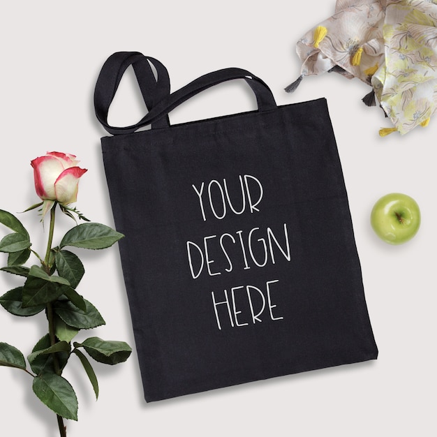 Mockup of black cotton tote bag, summer time scene ...