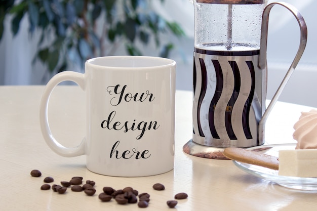 Download Mockup of a coffee mug on a table with sweets and french ...