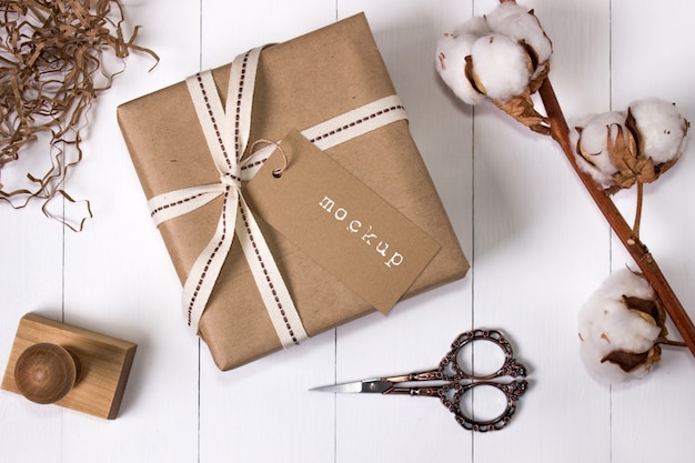 Download Mockup of a gift box in craft paper with tag | Premium PSD ...