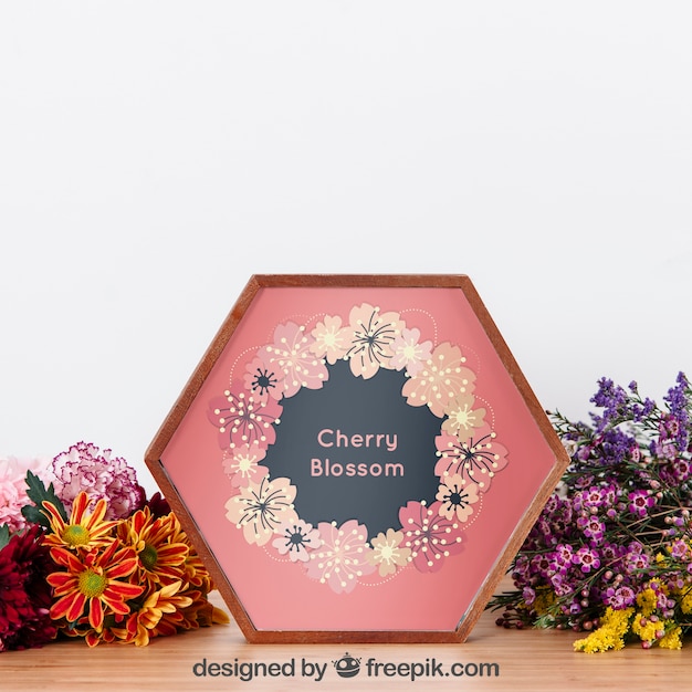 Download Mockup of hexagonal frame between flowers | Free PSD File