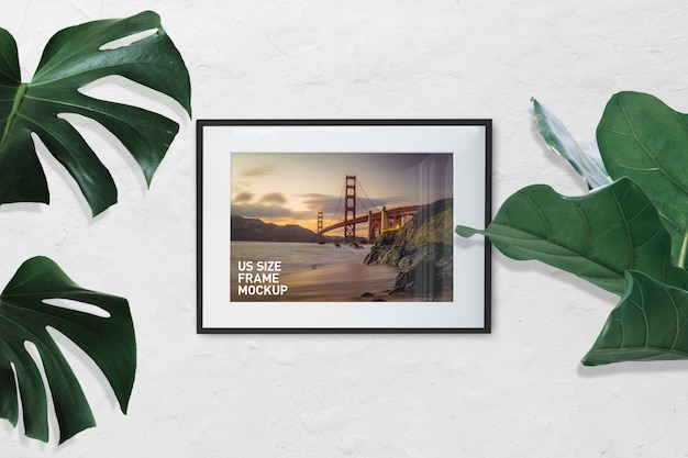 Download Mockup of landscape photo black frame on white wall with plants PSD file | Premium Download