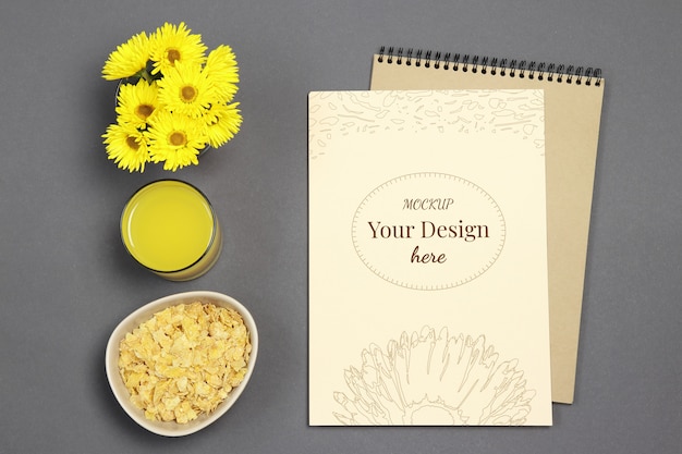 Download Mockup letter on grey background with yellow flowers, fresh juice and flakes | Premium PSD File