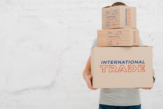 Download Mockup of man with cardboard boxes PSD file | Free Download