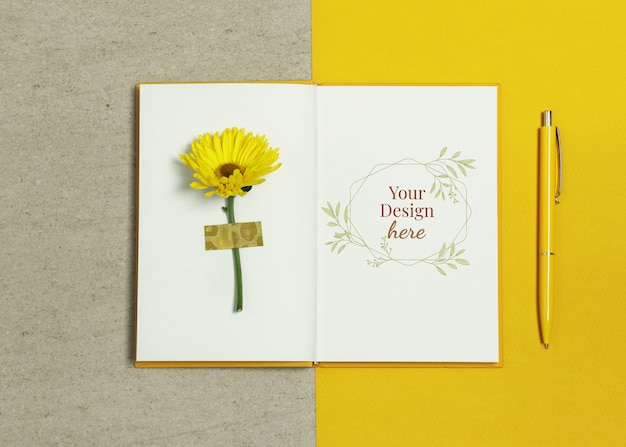 Premium PSD | Mockup notebook on yellow beige background with pen and summer flower