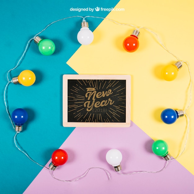 Download New year mockup with slate and bulbs | Free PSD File