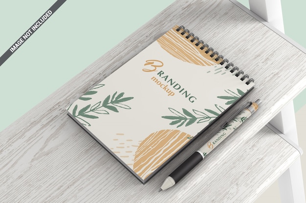 Download Notebook with pen lying on a wooden shelf mockup | Premium ...