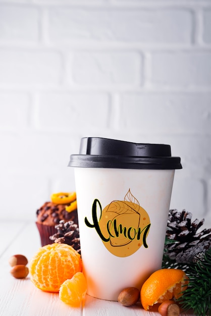 Download Paper cup of coffee surrounded by christmas decorations | Premium PSD File