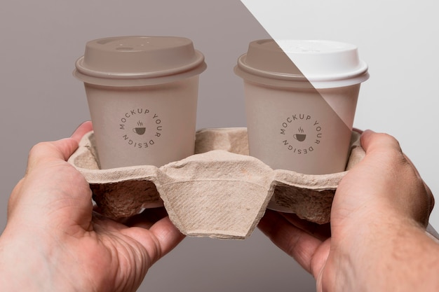 Download Free PSD | Plastic cups with coffee mock up in support