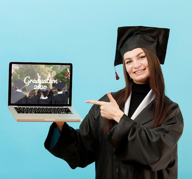 Portrait of student holding laptop | Free PSD File