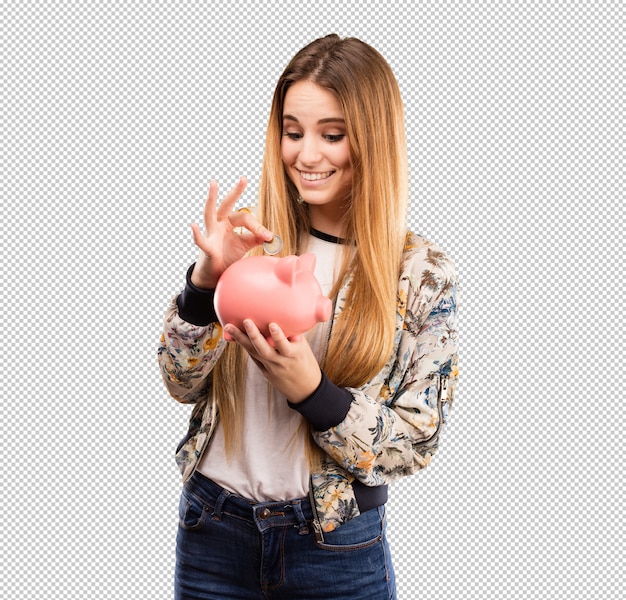 Pretty young woman using a piggy bank Premium Psd