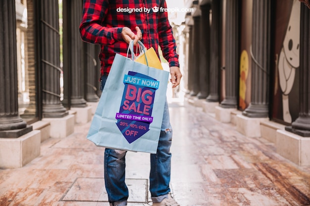 Download Shopping bag mockup with man in street | Free PSD File