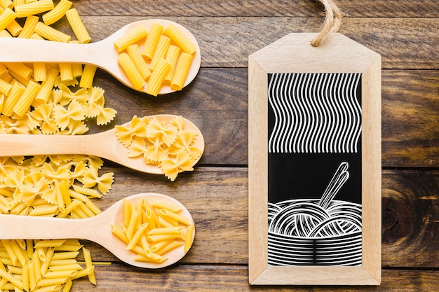 Download Slate mockup with pasta concept on wooden spoons | Free PSD File