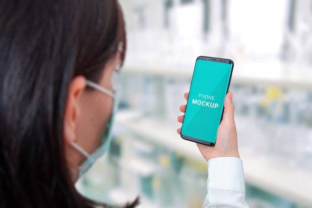 Download Premium PSD | Smart phone mockup in specialist hand. hospital laboratory in background