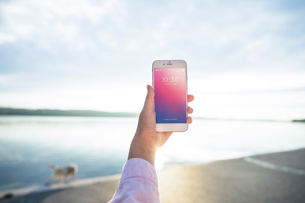 Smartphone mockup with woman at the beach | Free PSD File