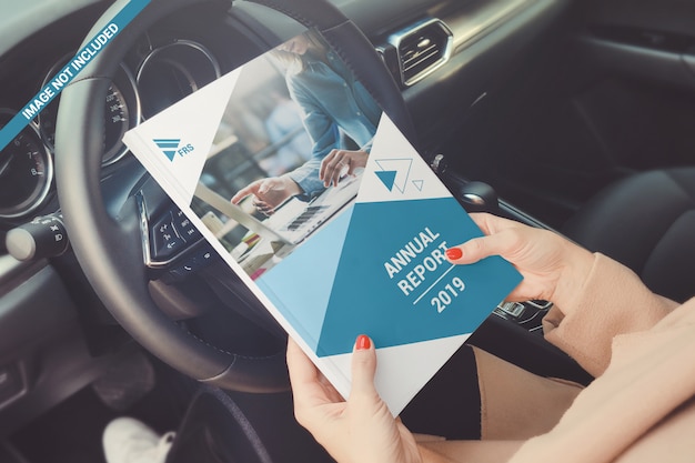 Download Premium Psd Soft Cover Book In Hand On The Car Steering Wheel Mockup