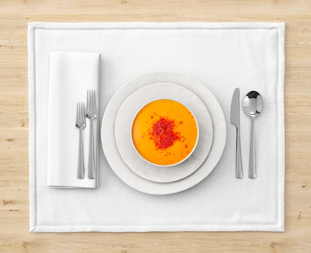 Download Soup on a bowl with place setting on wooden table | Free PSD File
