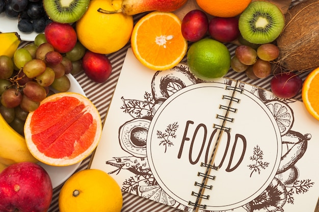 Spiral notebook mockup with fruits | Free PSD File