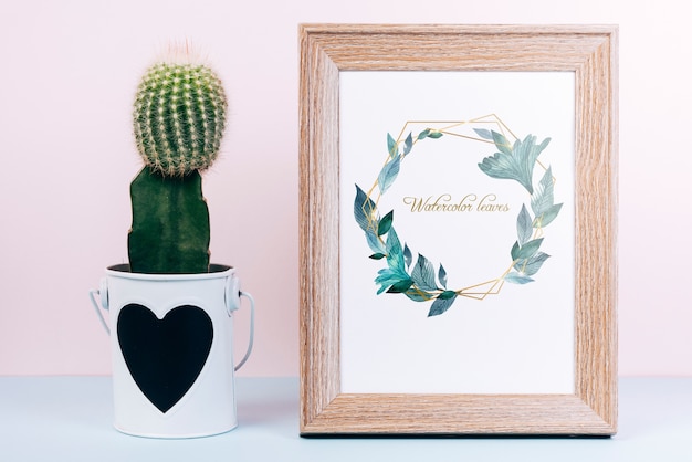 Download Spring mockup with wooden frame and cactus | Free PSD File