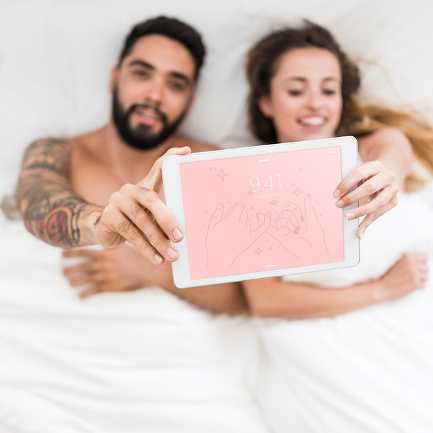 Download Tablet mockup with couple in bed | Free PSD File