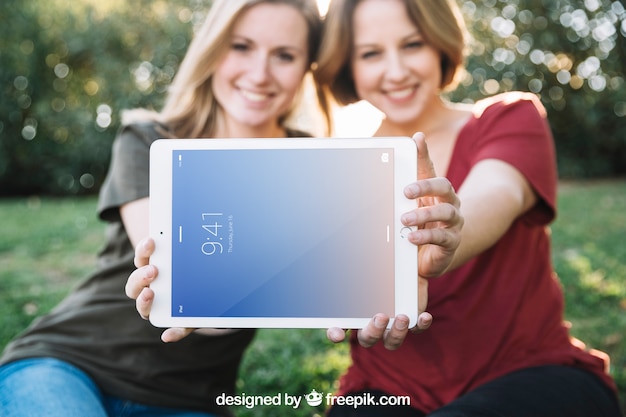 Tablet mockup with women in nature PSD Template
