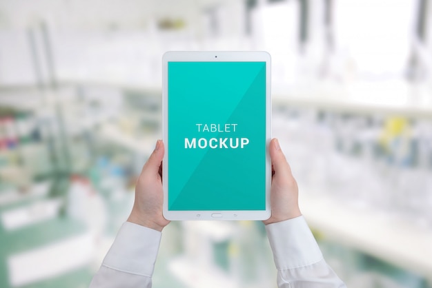 Download Tablet mockup in woman hands. hospital laboratory in background | Premium PSD File