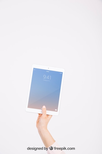 Technology mockup with hand showing tablet PSD Template