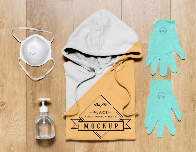Download Top view folded hoodie mock-up with gloves, mask and hand ...