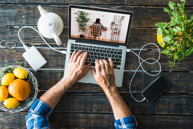 Top view laptop mockup with fruits PSD Template