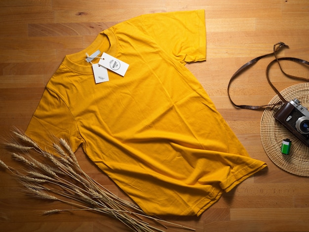 Download Premium PSD | Top view of mock up yellow t-shirt with mock up price tag on wooden table